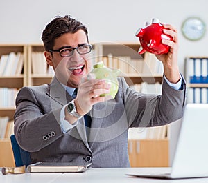 Businessman breaking piggybank in the office