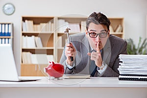 The businessman breaking piggybank in the office