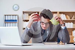 The businessman breaking piggybank in the office