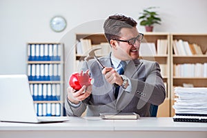 The businessman breaking piggybank in the office