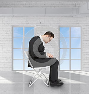 Businessman in brick room