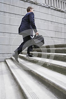 Businessman With Briefcase Ascending Steps