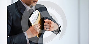 Businessman briefcase document envelope with dollar banknotes on white background. businessman putting illegal secret