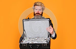 Businessman with briefcase full of money. Bearded man with case of dollars. Bribe, money laundering.