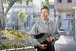 Businessman with briefcase outside office