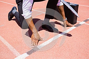 Businessman with briefcase ready to run