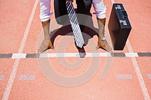 Businessman with briefcase ready to run