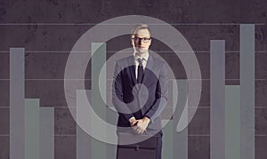 Businessman with briefcase standing on a column diagram background. Business, office, career, job concept.