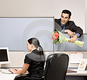 Businessman bringing co-worker flowers