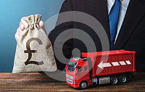 Businessman with british pound sterling money bag and truck. Good salaries for drivers. Rising prices, global containers shortage