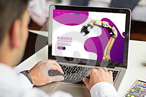 businessman browsing robotics website with computer