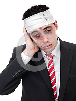 Businessman with bruised eyes and head