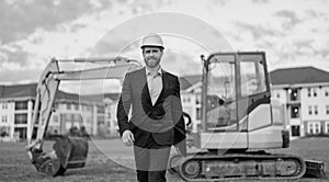 businessman with building plan. businessman inspect building plan at site. businessman inspecting building plan outdoor