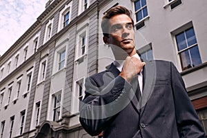 Businessman, buildings and thinking in city for travel to meeting, interview or job outdoors. Professional man, suit and