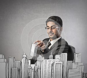 Businessman buliding a city