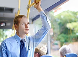 Businessman on the bus. a young businessman commuting to work.