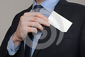 Businessman ,Business Man`s hand hold showing business card - close up shot on grey background. Show a blank piece of paper. Pape