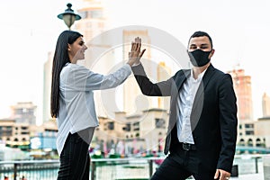 Businessman and business woman doing high five outdoors. Business concept. Successful concept. Coopearation concept