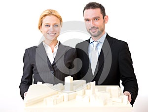 Businessman and business woman presenting model