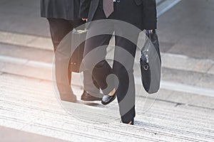 Businessman and Business woman up the stairs