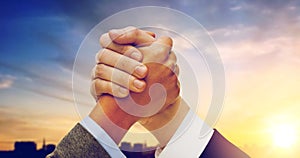 Businessman and businesswoman arm wrestling