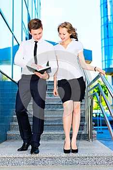 Businessman and businesswoman discussing document