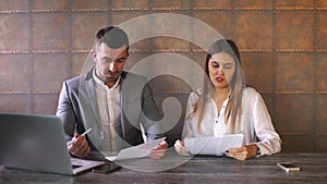 Businessman and businesswoman discussing work at lunch in a cafe