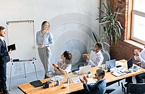 Businessman And Businesswoman Giving Speech Presenting Project Standing In Office