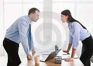 Businessman And Businesswoman Having Conflict At Work Standing In Office