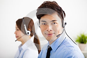 Businessman and businesswoman with headset working in office