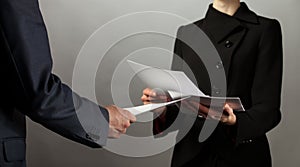 Businessman and businesswoman interchange of documents