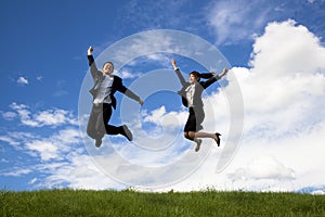 Businessman and businesswoman are jumping