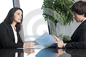 Businessman and businesswoman negotiating