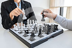 Businessman and businesswoman playing chess and thinking about strategy crash overthrow the opposite team and development analysis