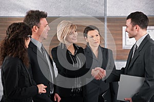 Businessman and businesswoman shaking hands