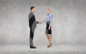 Businessman and businesswoman shaking hands