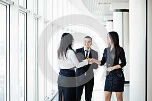 Businessman And Businesswoman Shaking Hands In Office hall at informal meeting