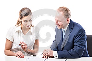 Businessman and businesswoman signing a papers