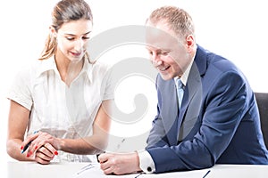 Businessman and businesswoman signing a papers