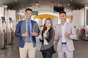 businessman and businesswoman smile, standing, give thumb up while working outside building in city.