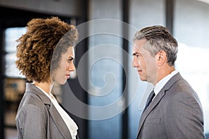 Businessman and businesswoman standing face to face