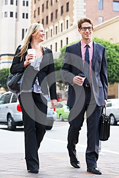 Businessman And Businesswoman In Street With Takeaway Coffee