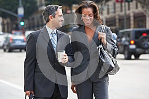 Businessman And Businesswoman In Street With Takeaway Coffee