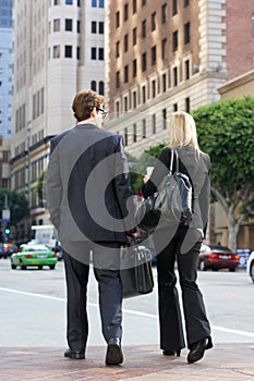 Businessman And Businesswoman In Street With Takeaway Coffee