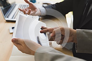 Businessman And Businesswoman using a digital tablet to discuss