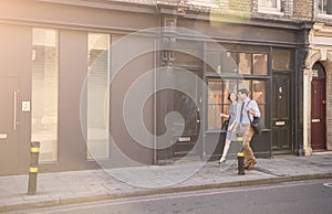 Businessman And Businesswoman Walk to Work Through City Street