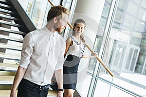 Businessman and businesswoman walking and taking stairs