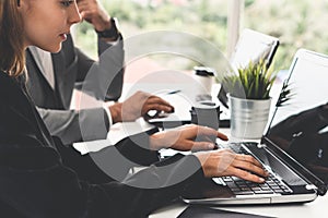 Businessman and businesswoman working in office.