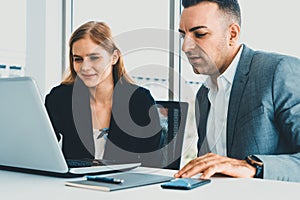 Businessman and businesswoman working in office. uds