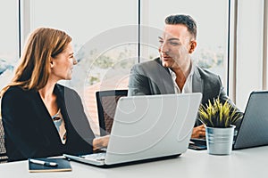 Businessman and businesswoman working in office. uds